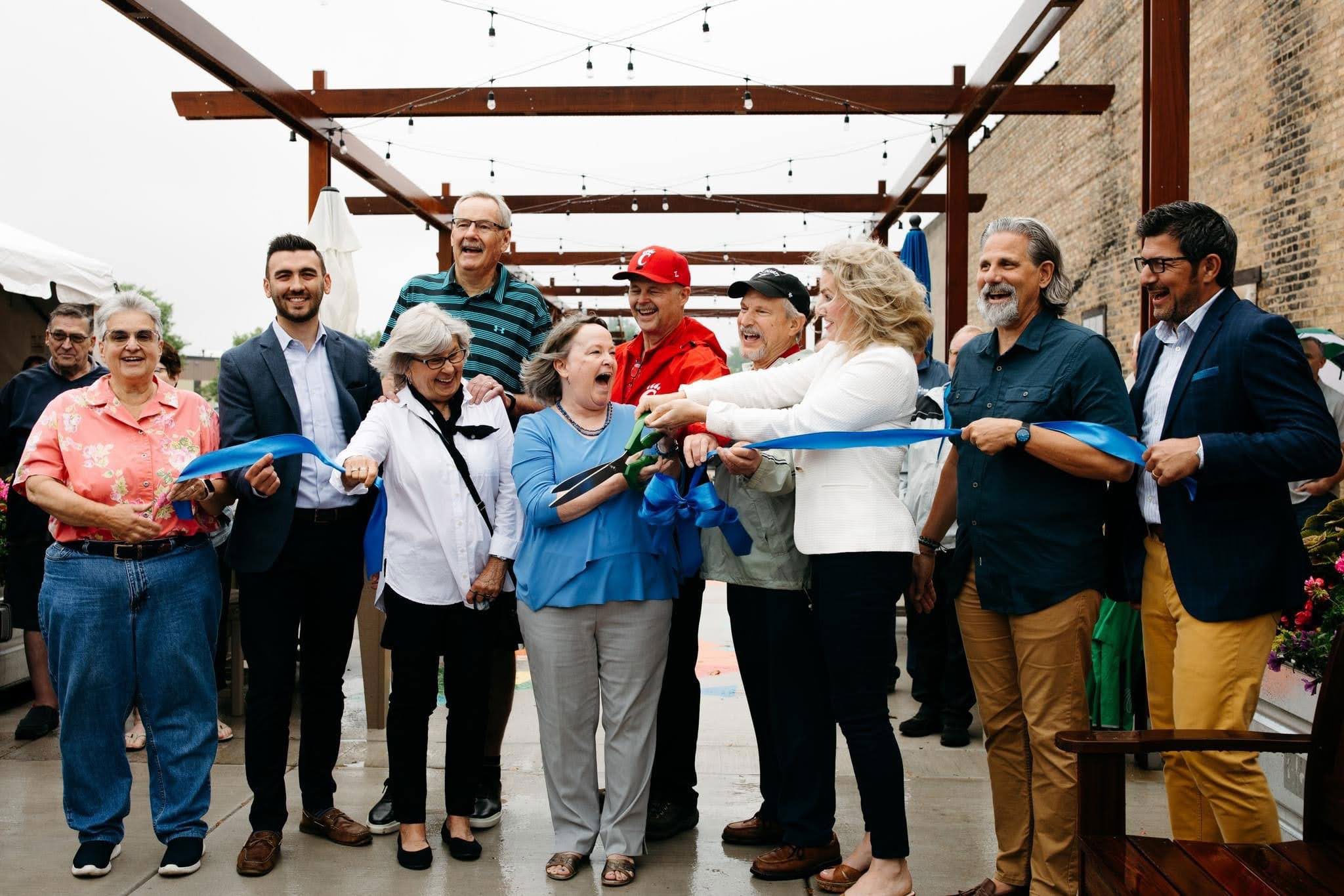 Group photo at ribbon cutting for Magic Carpet event