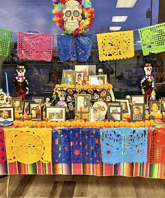 Table display of family photos and colorful flags