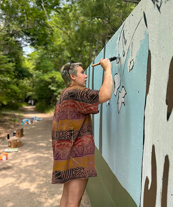 Person painting a mural