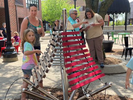 People playing music on a xylophone installation