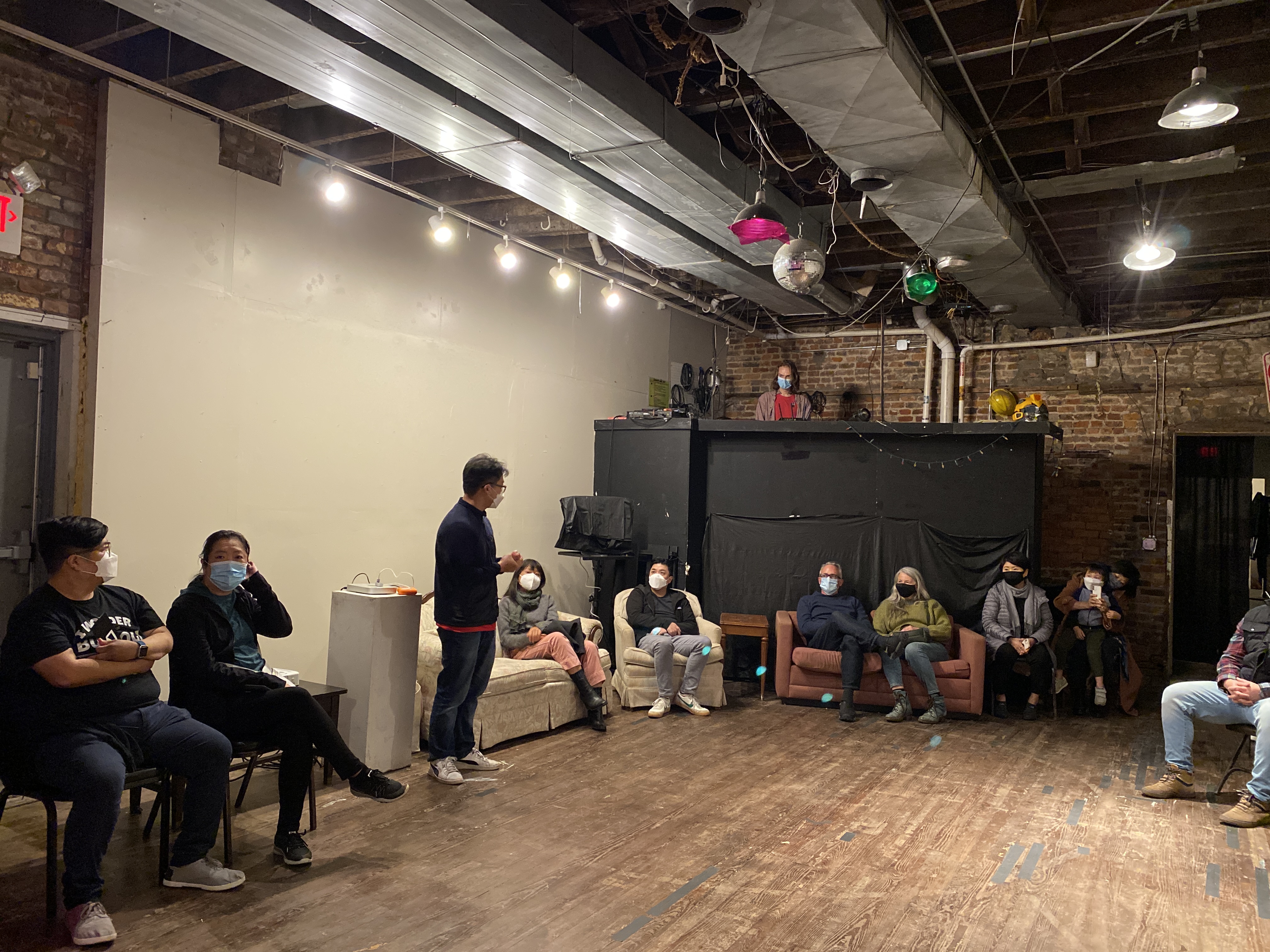 People sitting in a circle around a room