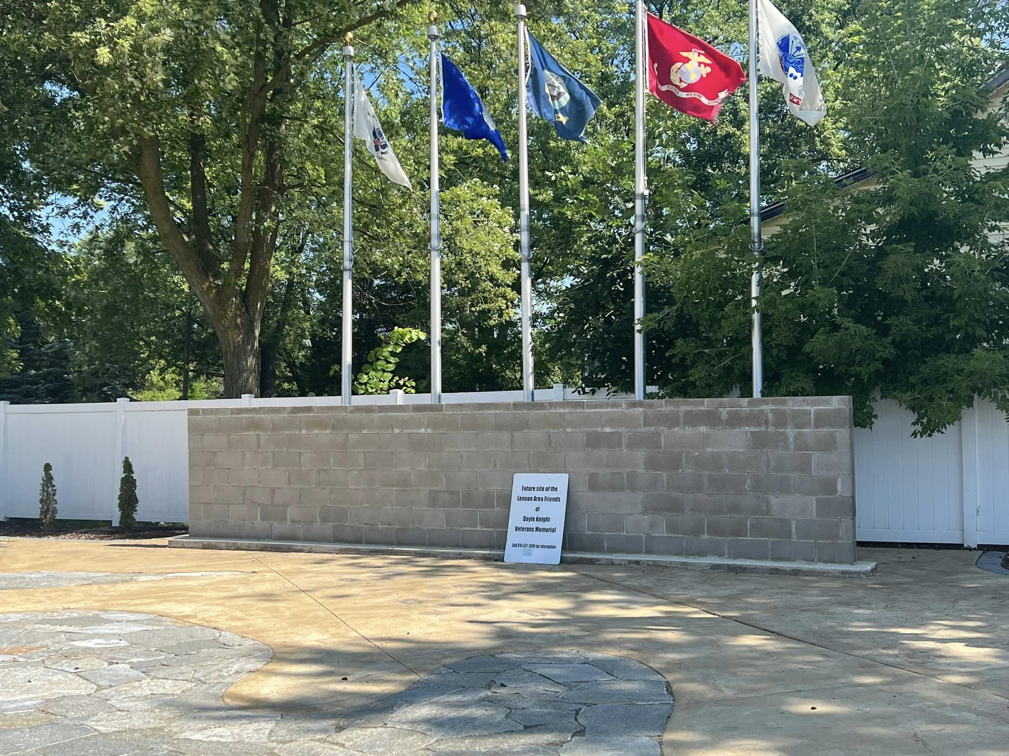 Photo of wall and flags set up for a veteran's memorial