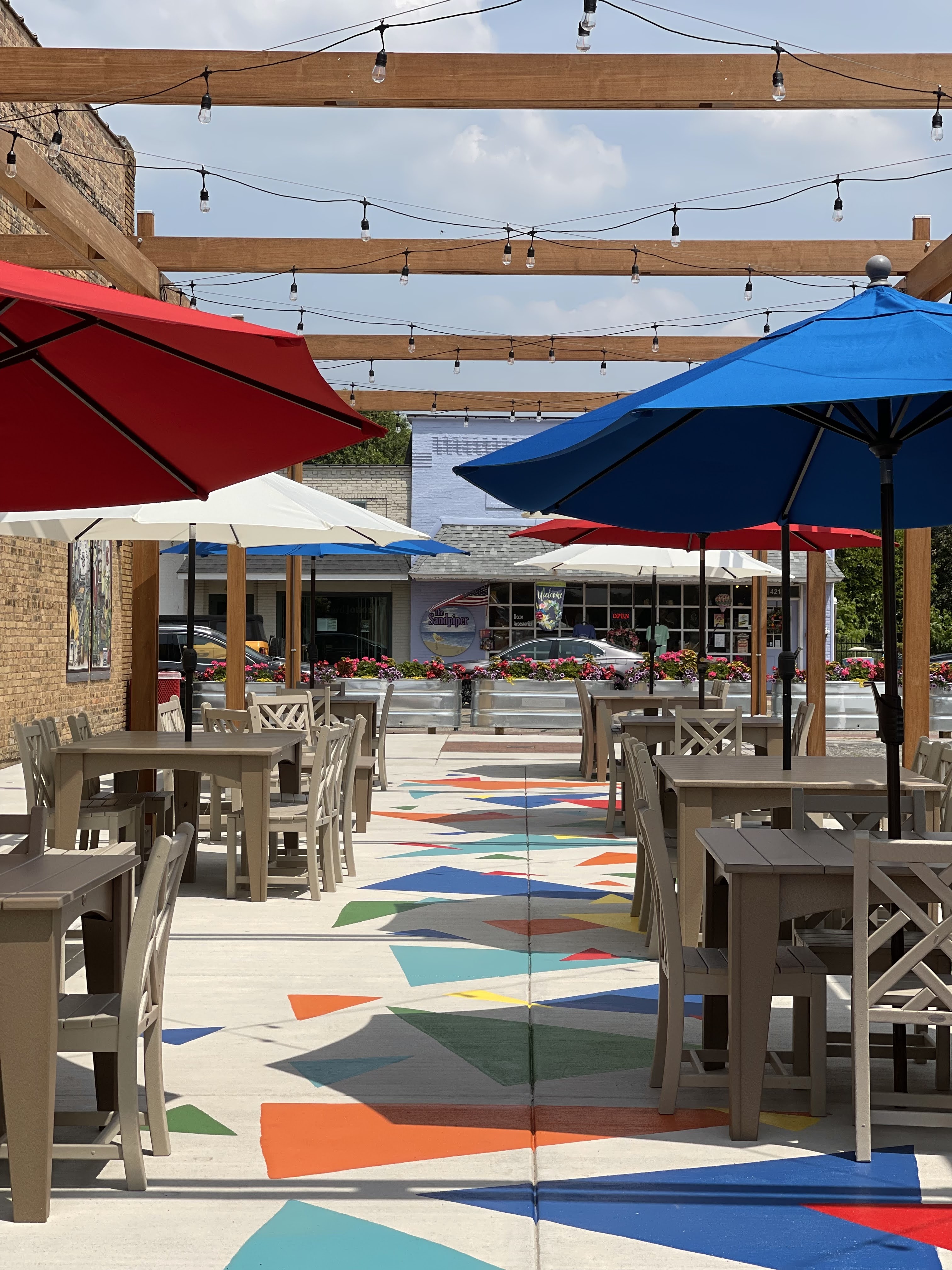 Photo of patio with tables and a mural on the floor