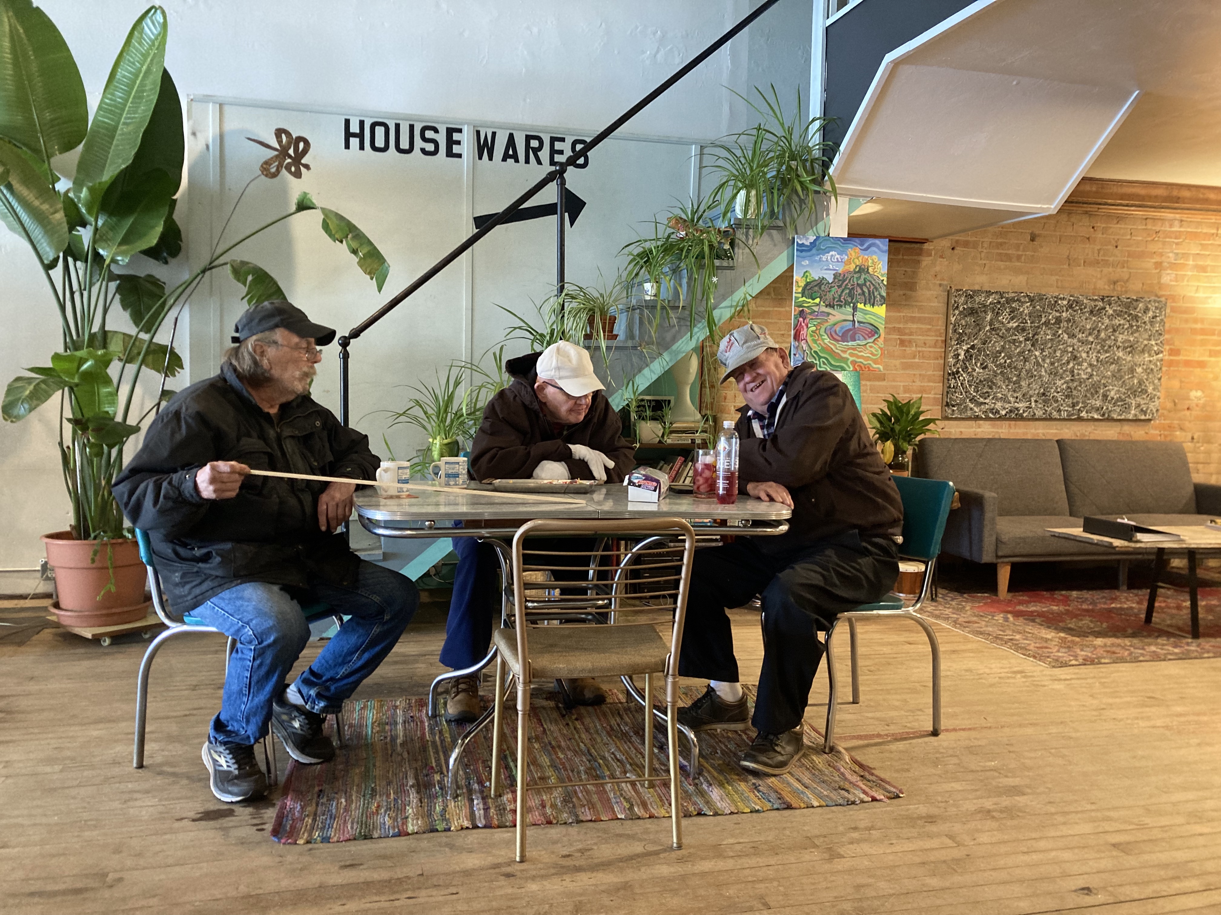 Older men sitting around a table laughing